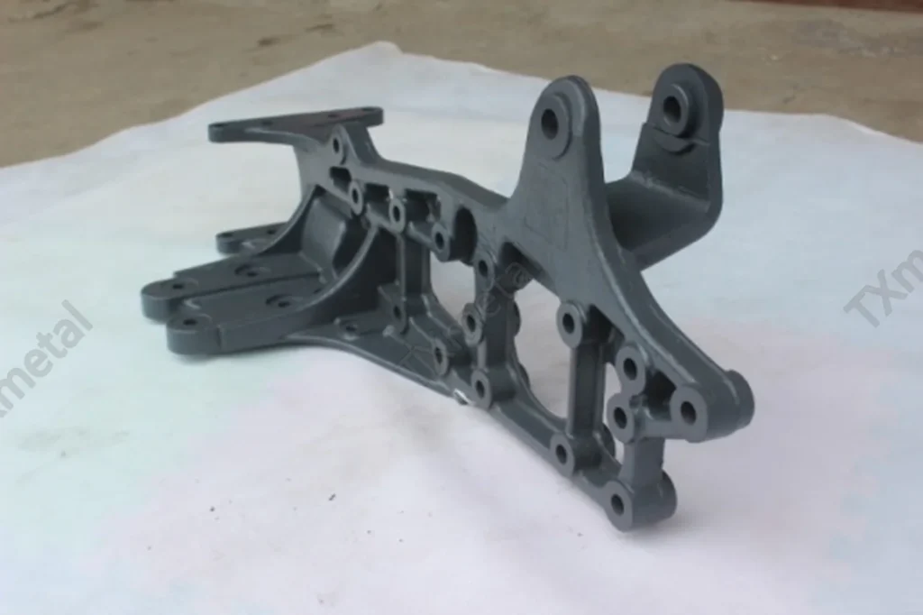 Ductile iron suspension and steering bracket casting for automotive chassis systems.