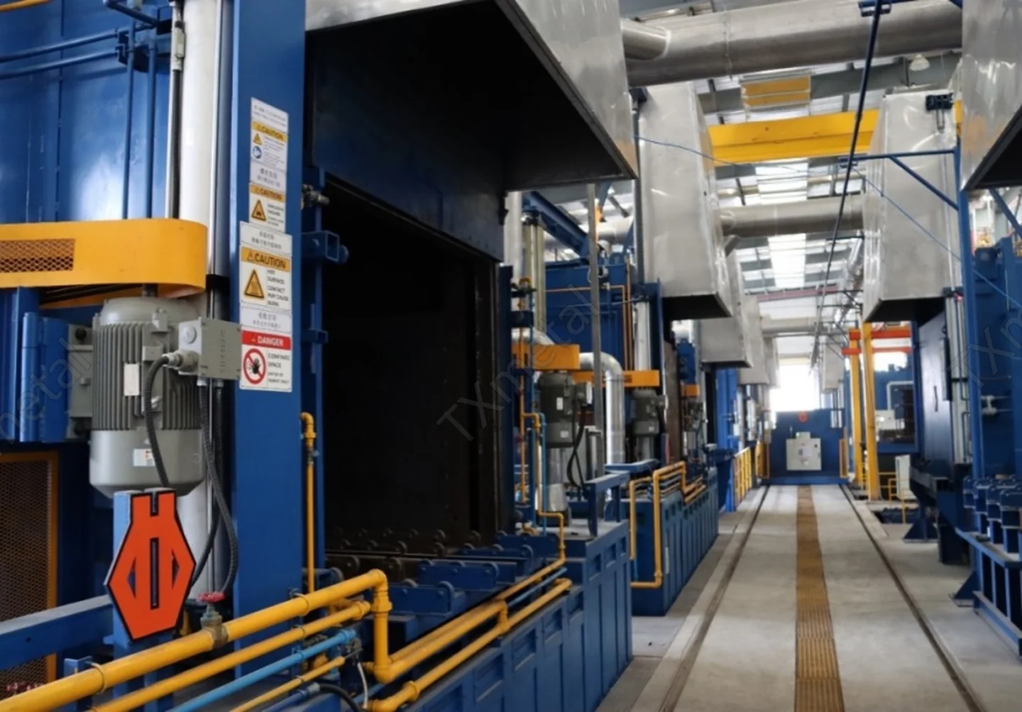 Heat treatment furnace line for processing gray iron, ductile iron, and ADI castings in a modern foundry.